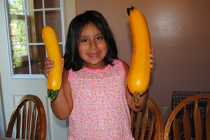Lili planted the yellow squash and is very proud of her accomplishments.