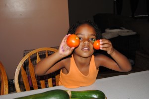 Naomi helped pick the tomatoes and needed to be in a picture too.