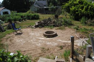 Our newly built fire pit, sitting all alone in a pit of sand.